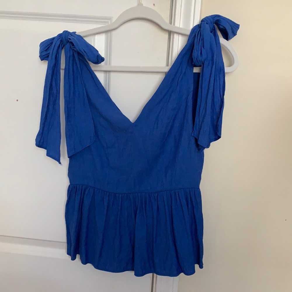Peplum top with bow shoulder ties